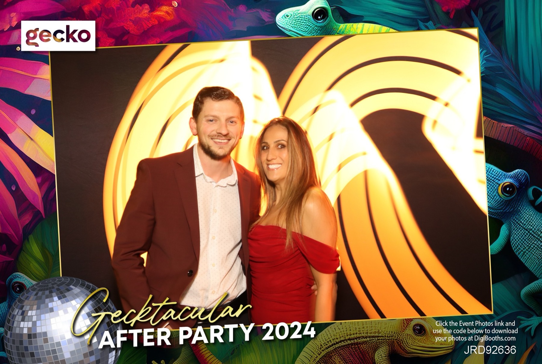 Light-painting booth portrait — glowing golden swirls of light painted around a couple in the dark