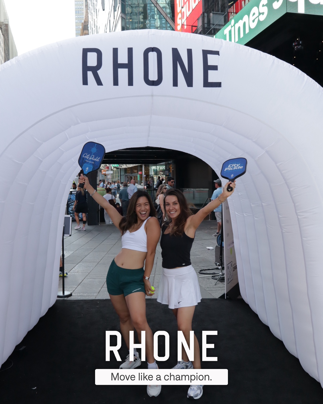 Guests posing together inside the branded Rhone tunnel, photo captured by the roaming photographer with the Rhone branded overlay