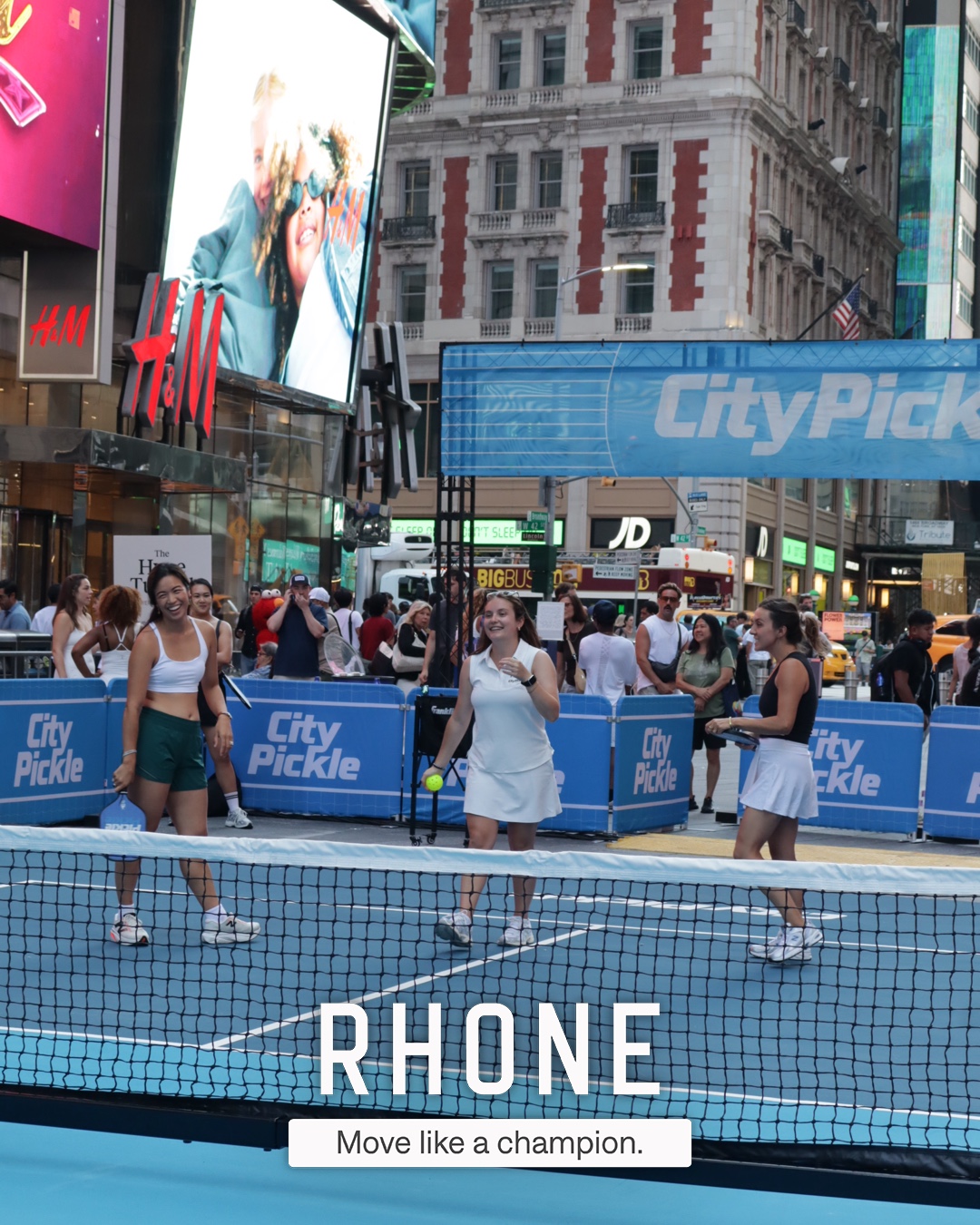 Guests at the Rhone activation in Times Square, photo carrying the branded 'Move like a champion.' overlay