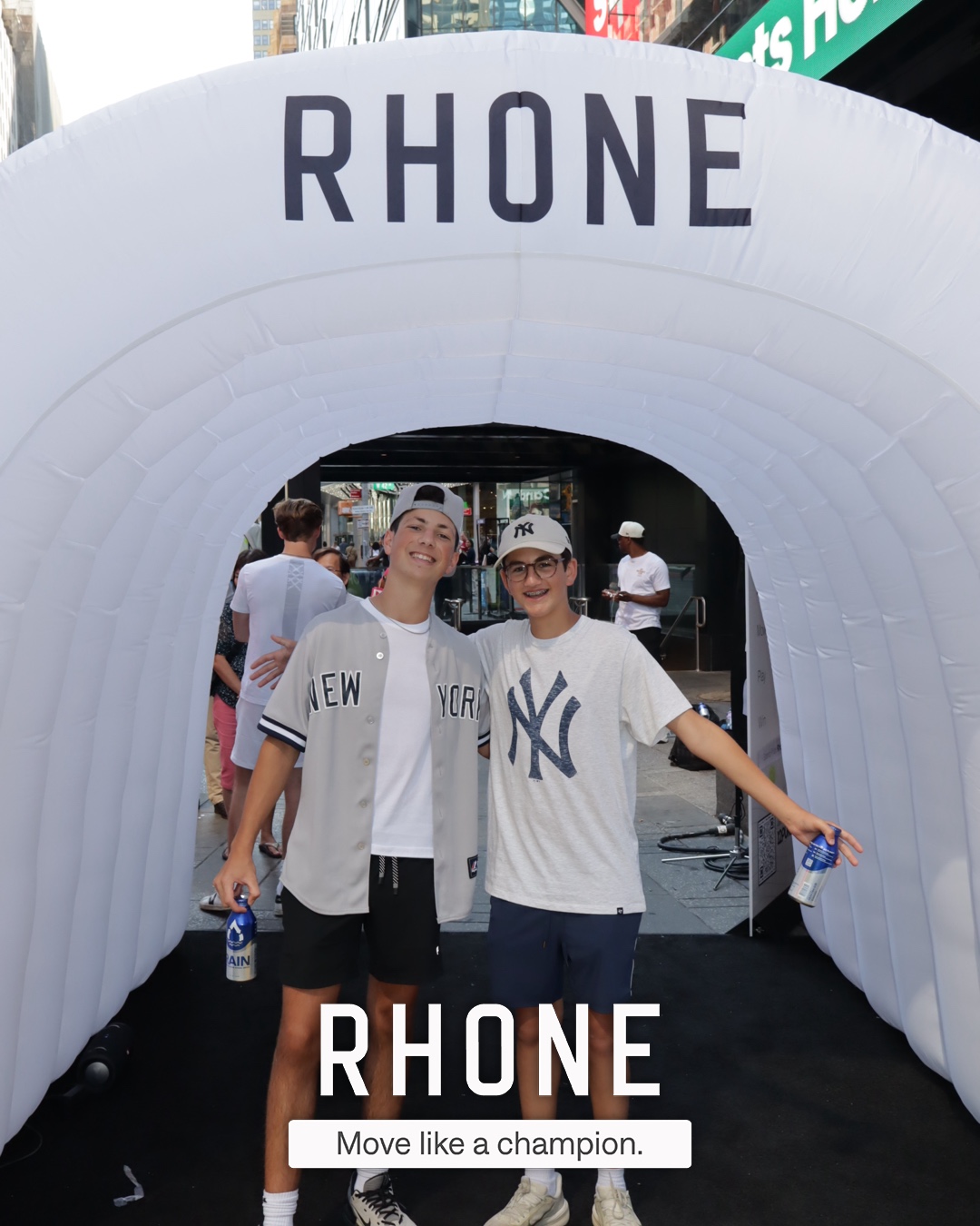 Guests posing at the Rhone tunnel activation, branded overlay applied by the roaming photography crew