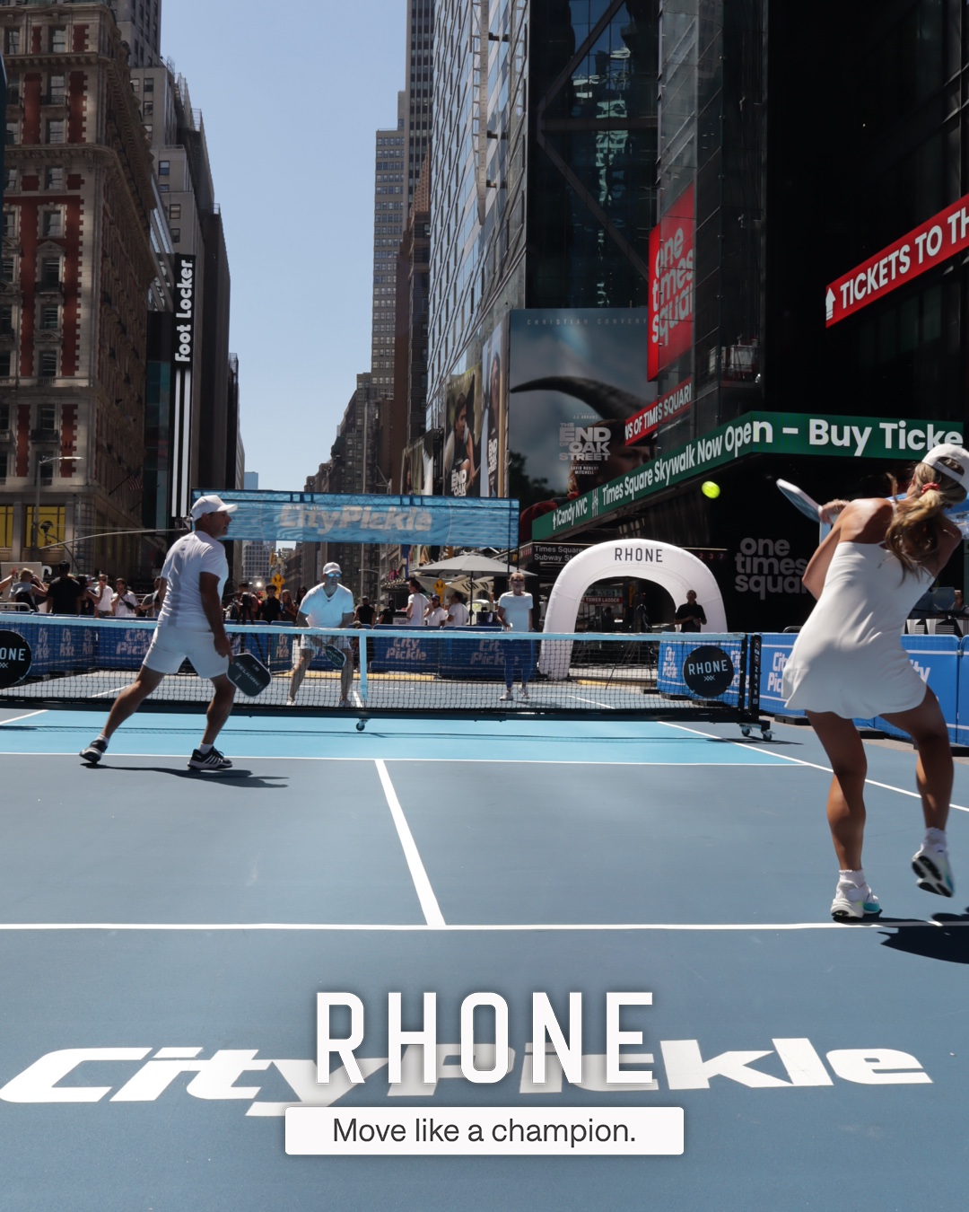 Guests posing inside the branded Rhone tunnel at CityPicklePalooza in Times Square, Manhattan