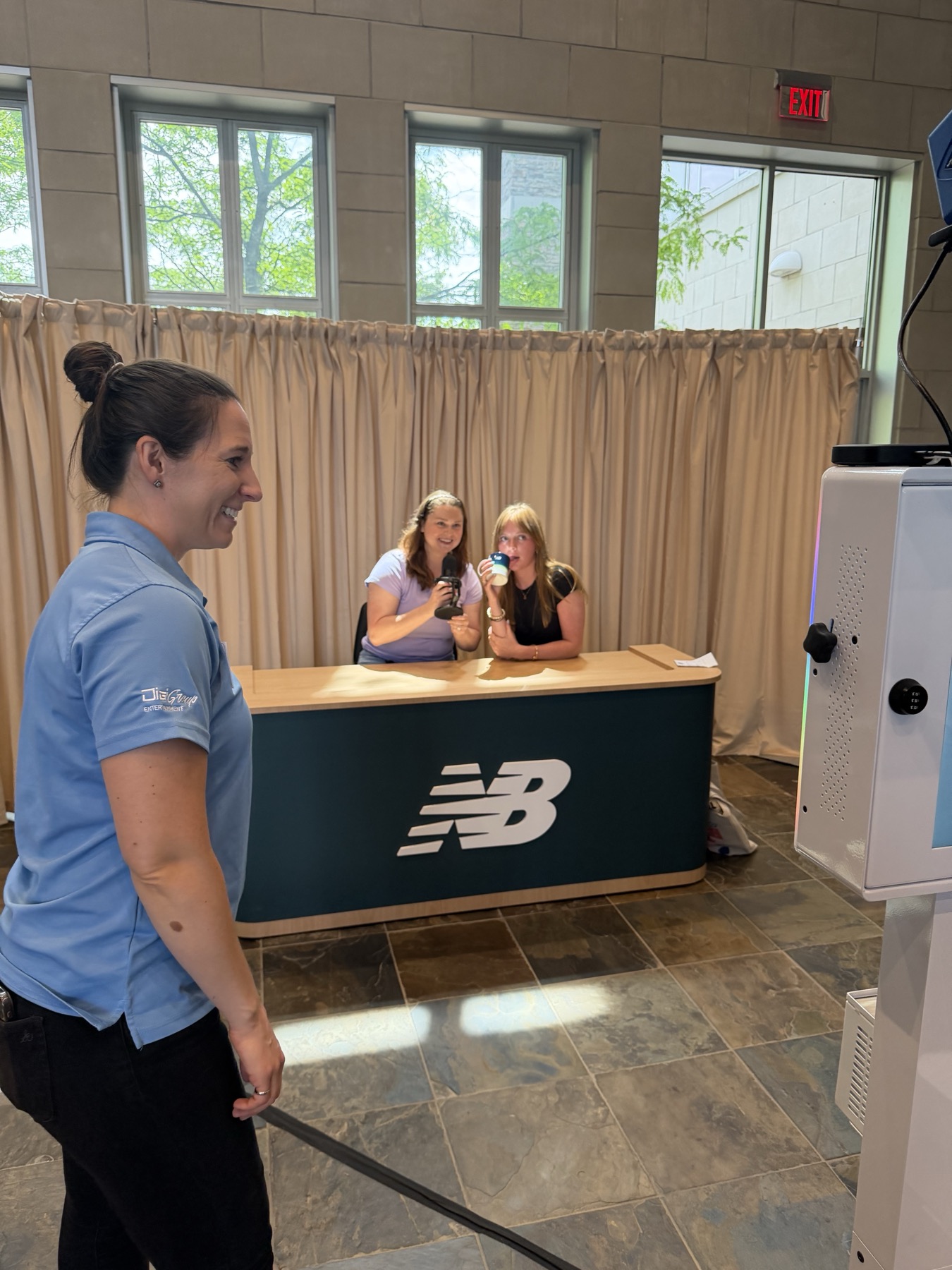 The New Balance branded activation desk at the Dick's Sporting Goods headquarters in Pittsburgh, with guests posing for a photo
