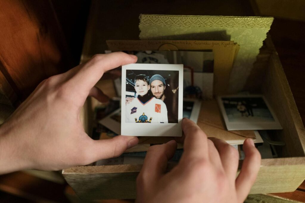 A person holding a photo booth picture