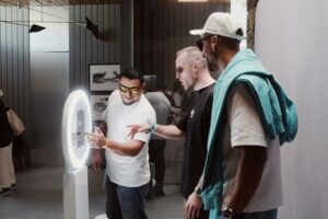 Two men are taking a picture using a photo booth