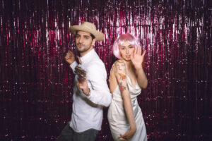 A couple posing for the photo booth