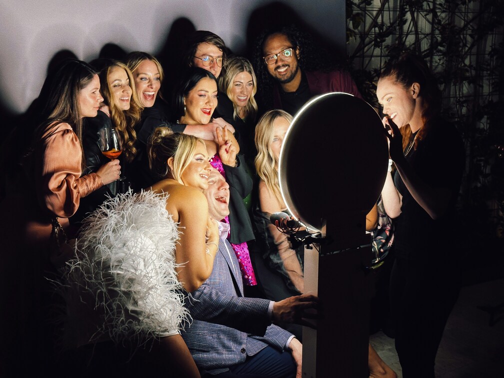 A group of people using a photobooth