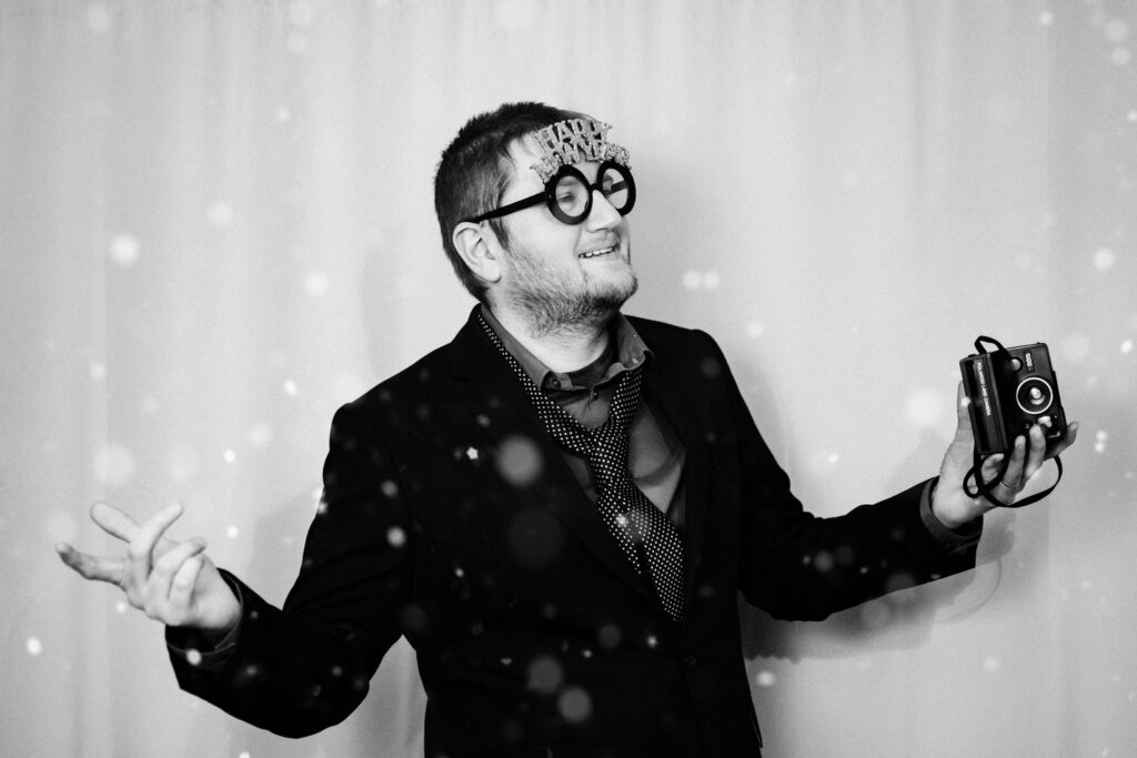 A man striking a pose in a glam photo booth