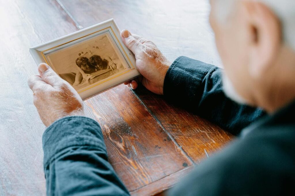 A person holding a framed photo booth picture