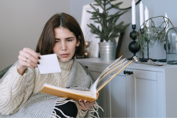 A woman looking at photobooth photos in a photo album