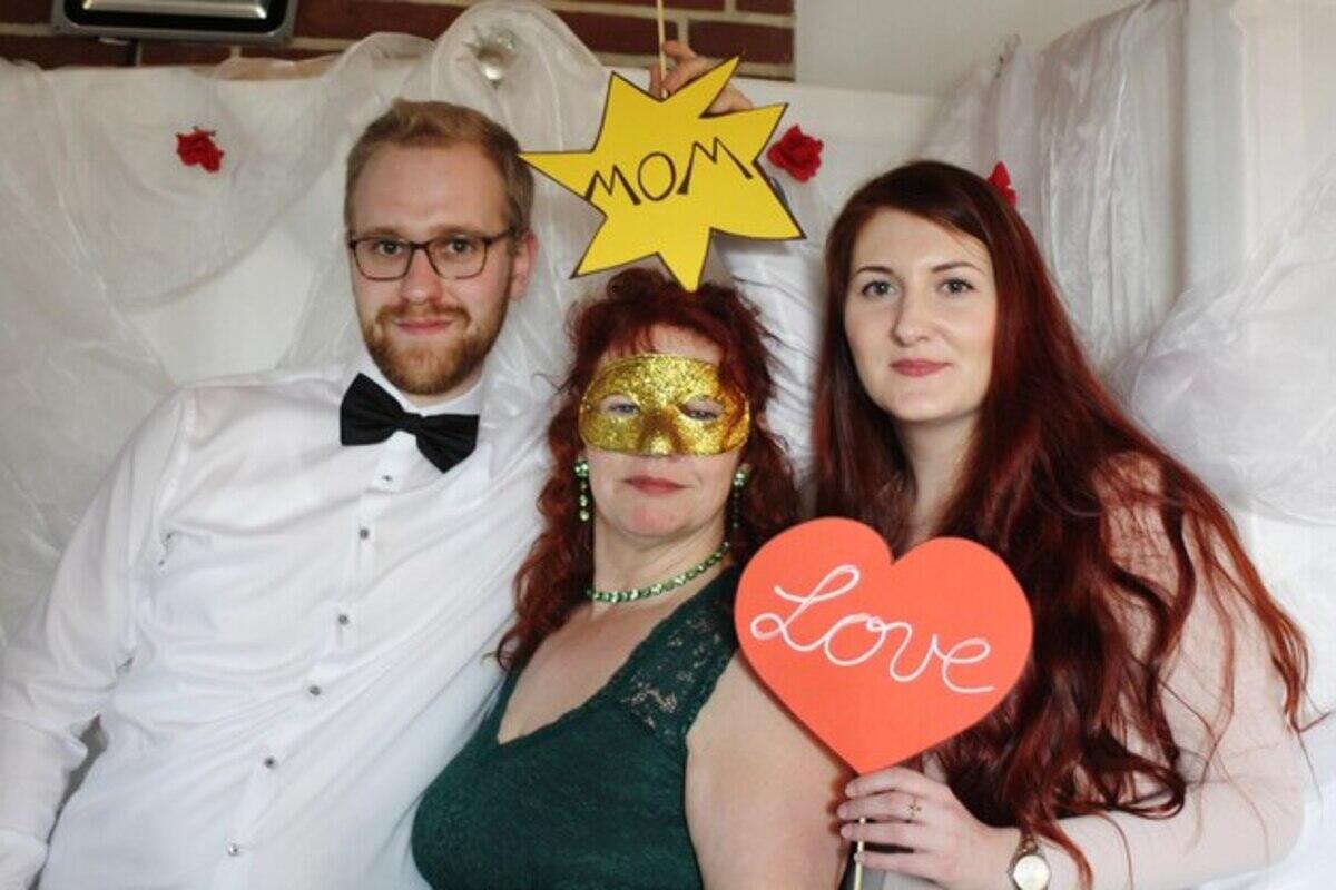 A family taking their pictures in the photobooth