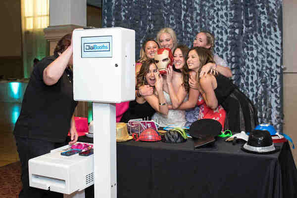 A photobooth attendant entertaining the guests