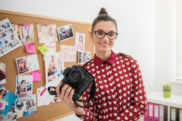 A young girl takes various pictures of her poses to determine her best angle