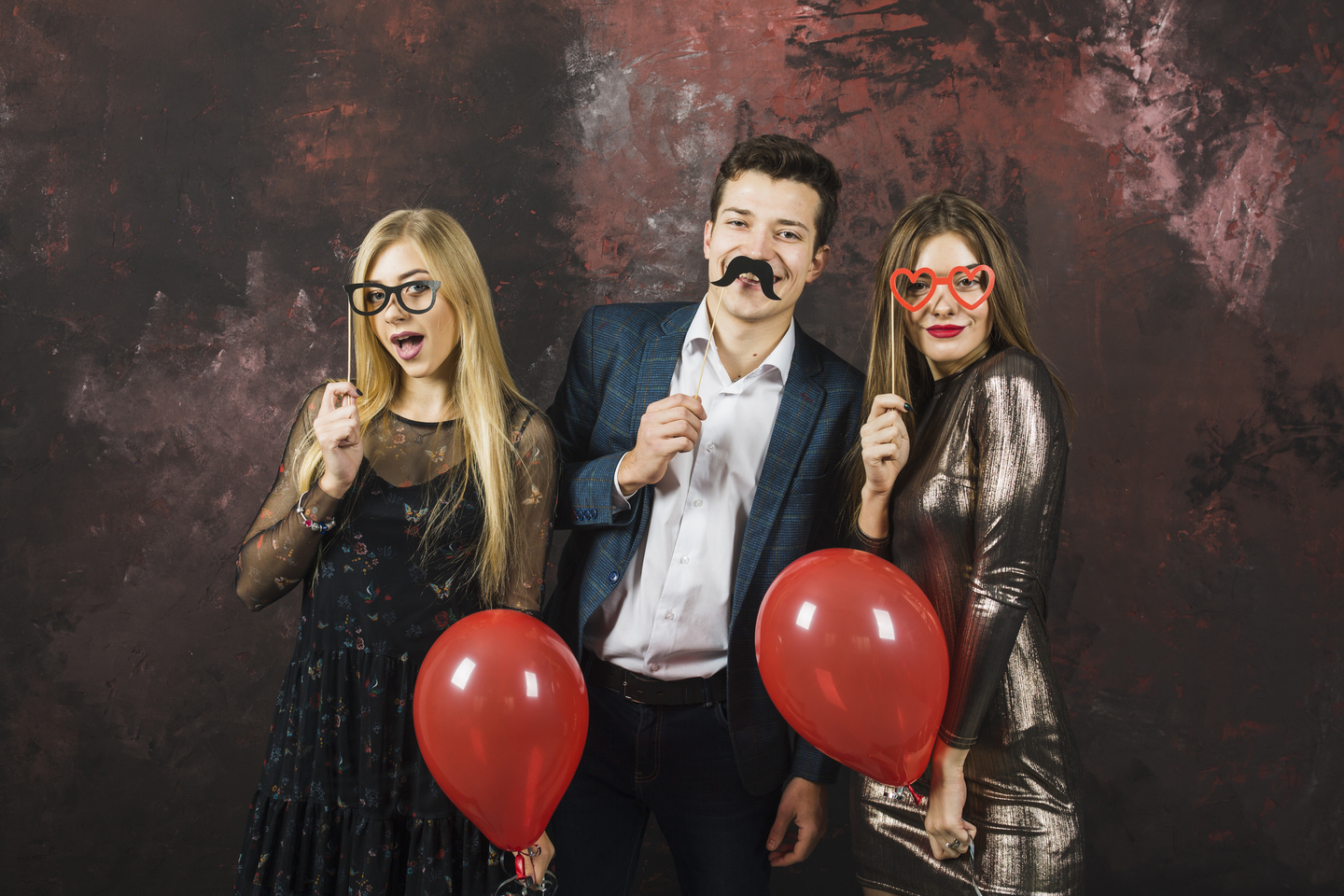 Three people posing for a photo booth