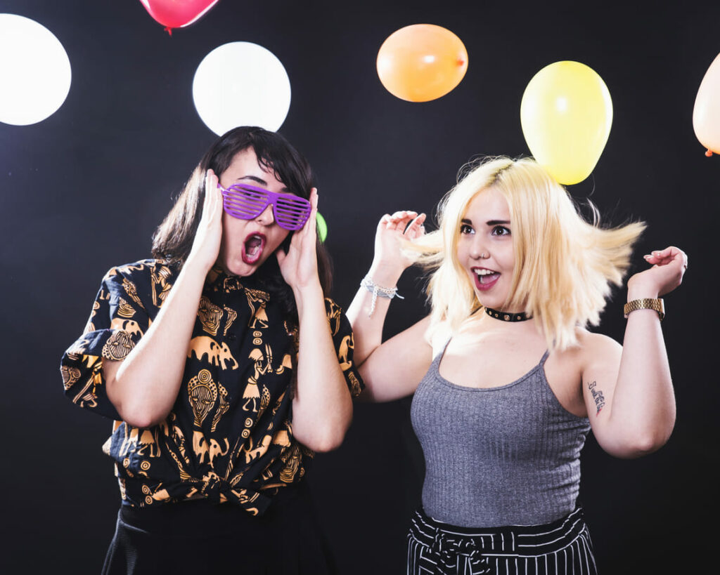 Two women enjoying a photo booth