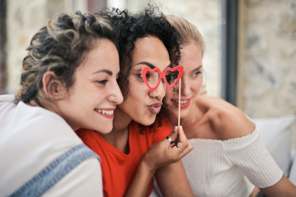 Three women posing for a photo booth picture