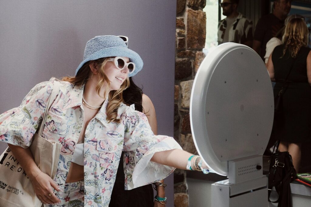 Two women using a photo booth