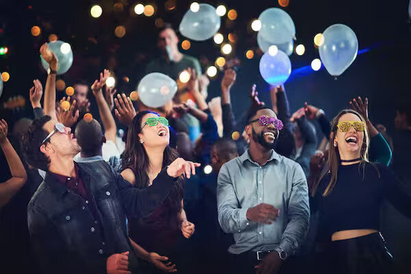 A group of people enjoying the party