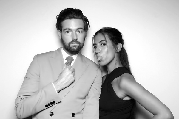 Couples taking romantic pictures in a Glam Booth during a wedding event