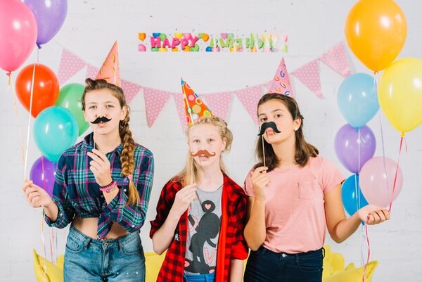 Kids wearing photo booth props during a birthday party