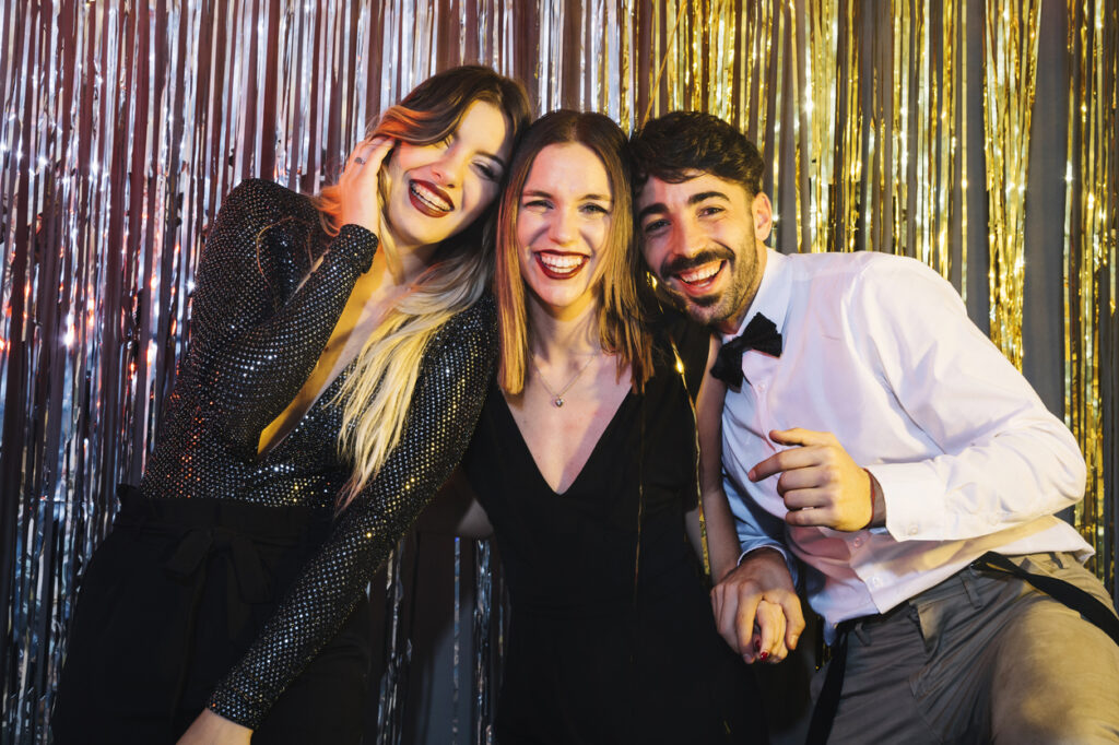 Friends enjoying the corporate party while posing in the photo booth.