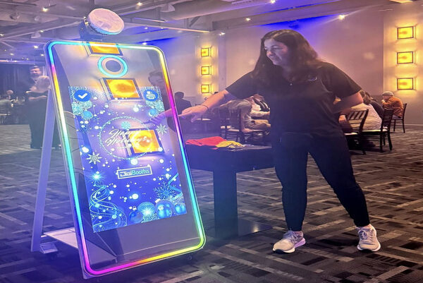 Attendees engaging with a photo booth during a corporate event