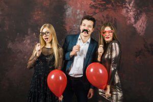 Three friends enjoy the corporate event using Photo Booth