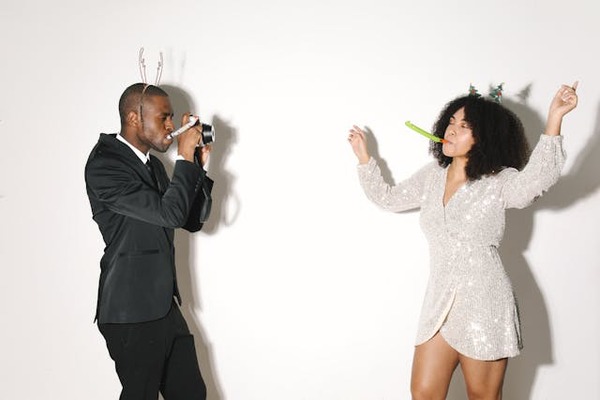 a man and woman having fun in photo booth