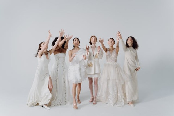 brides in wedding dresses in white backdrop