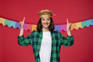 girl in green shirt taking a picture in a photo booth
