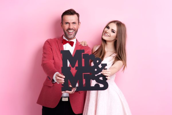 young married couple posing in photo booth