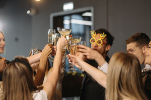A family reunion with family members toasting glasses and smiling