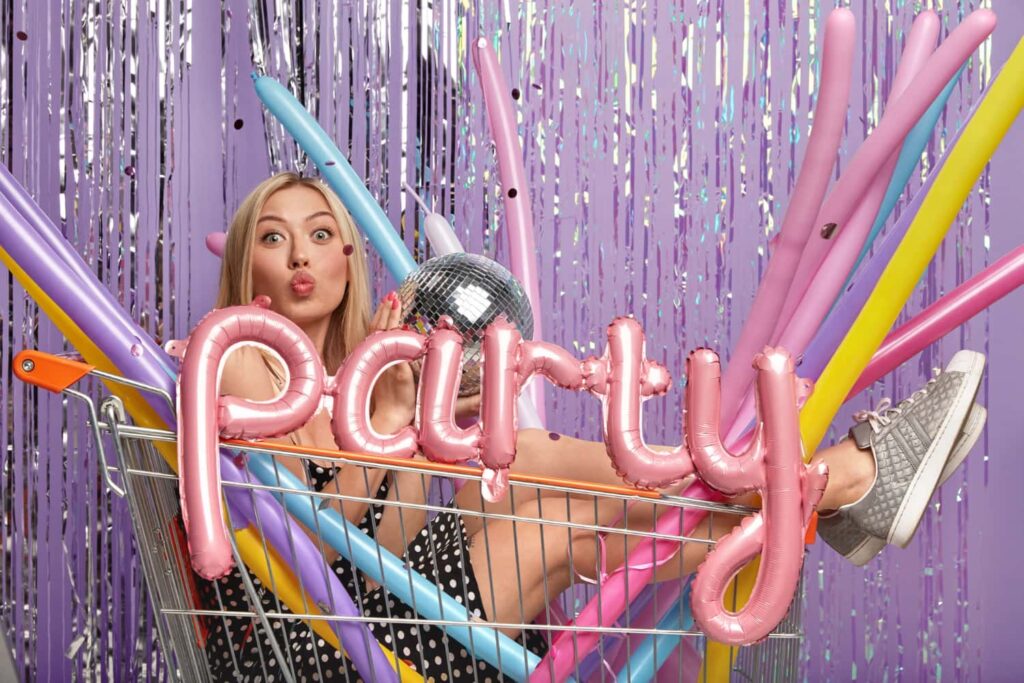 A girl riding a pushcart and posing in a photo booth