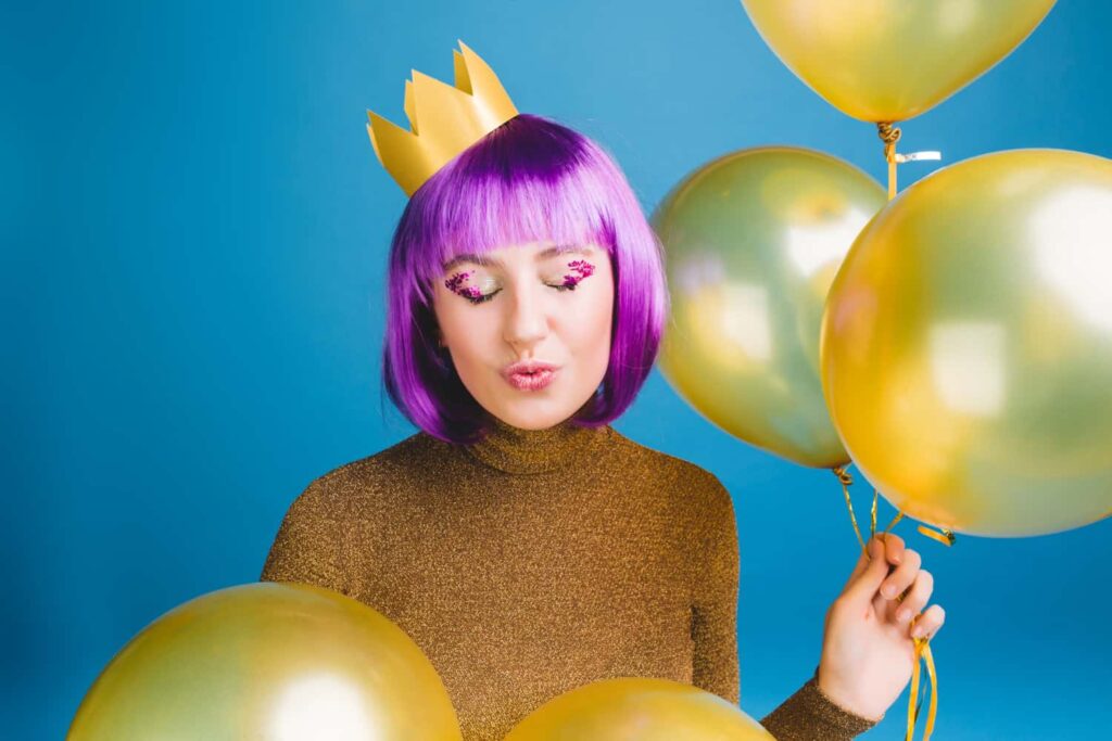 A woman celebrating her birthday and posing for a photo