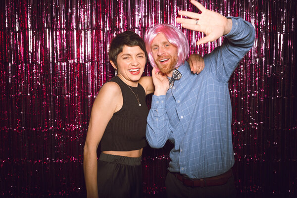 Guests posing playfully at reunion events photo booth.