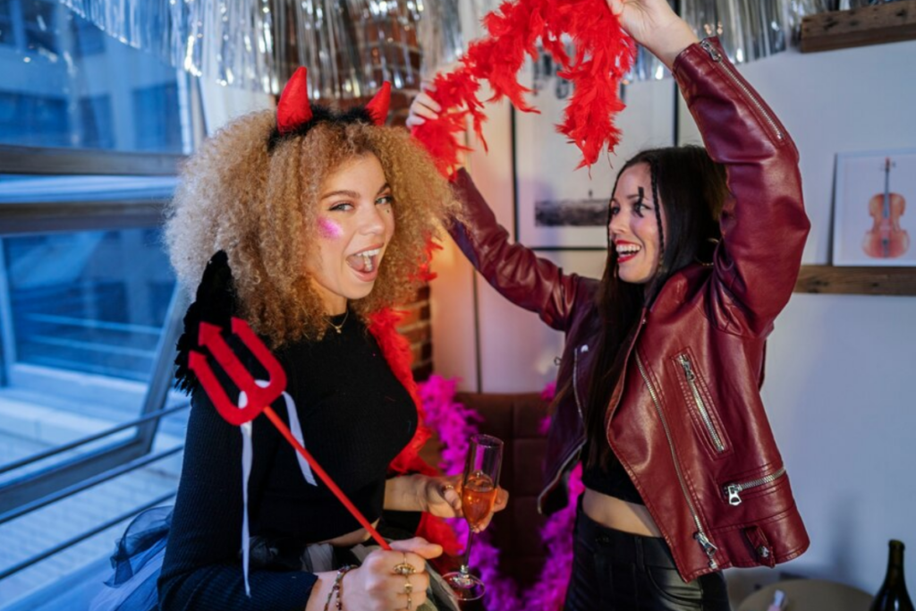 Two women preparing costumes for a photo booth session