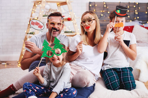 Family posing with props during fun holiday reunions at home.