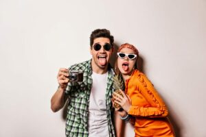 friends making silly faces in a photo booth during a fun-filled reunion event