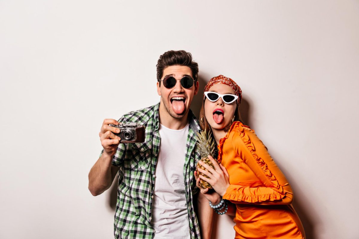 friends making silly faces in a photo booth during a fun-filled reunion event